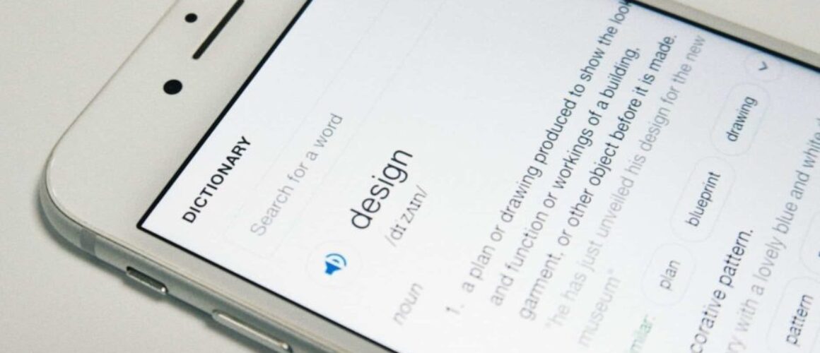 Picture of a white iPhone displaying a dictionary search result for the word "design"